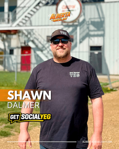 Portrait of Shawn Dalmer in a dark T-shirt and cap, outdoors near a metal building, with the overlaid text 'SHAWN DALMER' and 'GET SOCIAL YEG'.