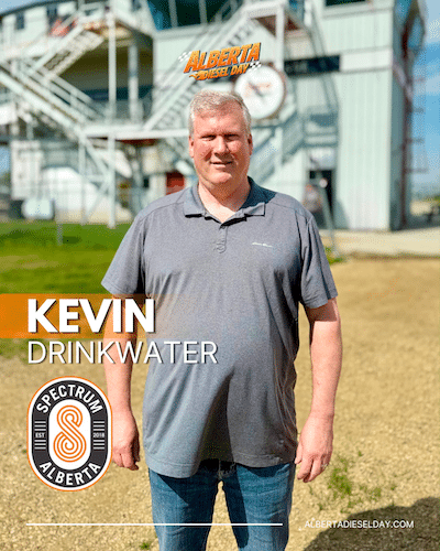 Portrait of Kevin Drinkwater outdoors in a gray polo; large overlaid text shows his name and the Spectrum Alberta logo appears in the lower-left.